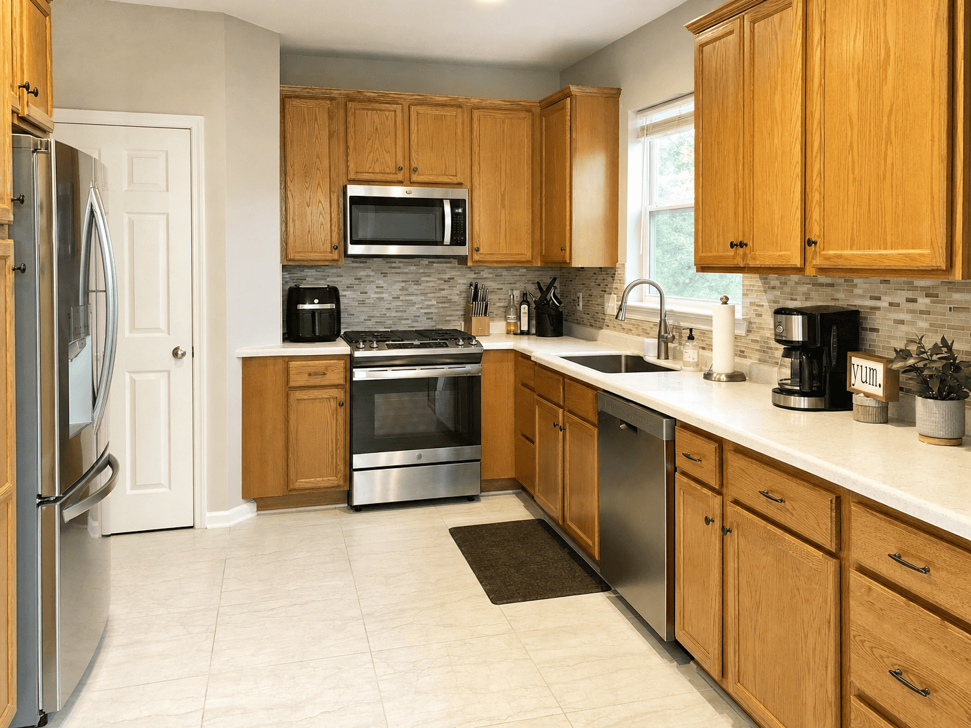 Clean kitchen with wood cabinetry and stainless appliances